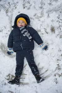 Full length of child on snow covered field