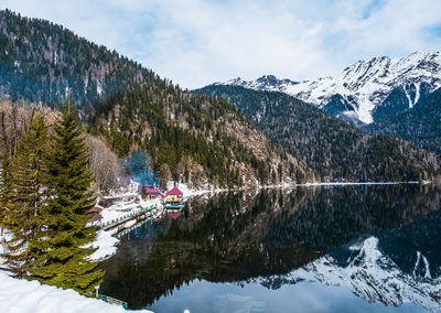 Scenic view of lake and mountains against sky