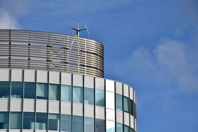 Low angle view of office building against blue sky