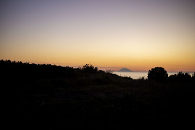 Scenic view of silhouette landscape against clear sky during sunset