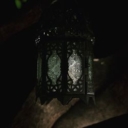 Close-up of illuminated lamp in dark room