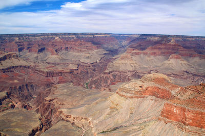 Scenic view of desert against cloudy sky