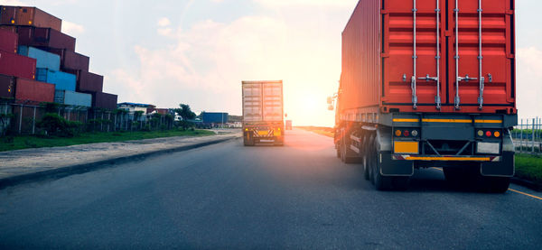 Vehicles on road along buildings in city