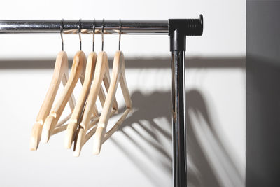 Close-up of clothes hanging on wooden table