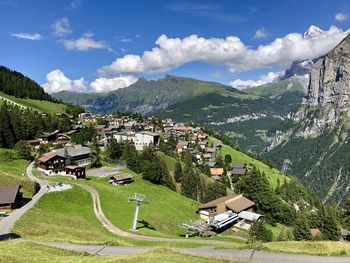 Scenic view of landscape and houses against sky