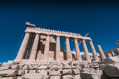 Low angle view of ancient built structure against clear blue sky