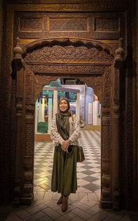 Portrait of woman standing in historic building