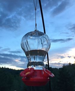 Low angle view of hanging light against sky