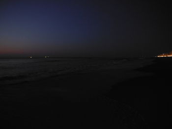 Scenic view of sea against clear sky at night