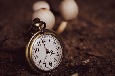 Close-up of pocket watch on land