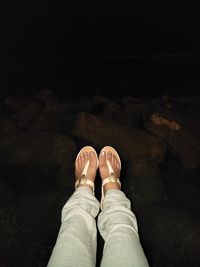 Low section of woman standing on shore