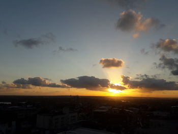 Aerial view of city against sky during sunset