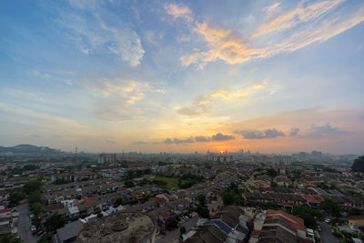 Aerial view of cityscape against sky during sunset