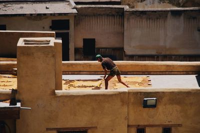 Man working at construction site against building