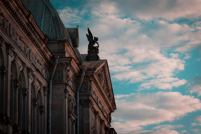 Low angle view of statue against historic building