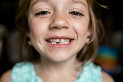 Close-up portrait of girl showing gap tooth