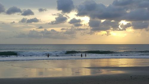 Scenic view of beach against sky during sunset