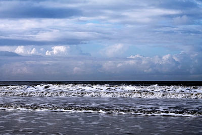 Scenic view of sea against cloudy sky