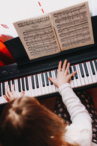 Low section of woman playing piano