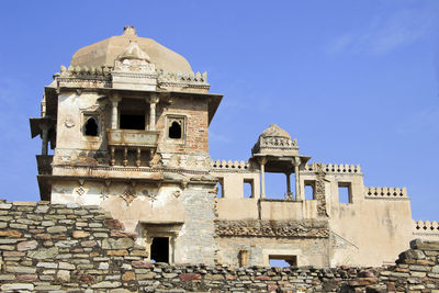 Low angle view of old building against blue sky