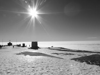 Scenic view of beach against sky on sunny day