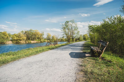 Road amidst trees against sky