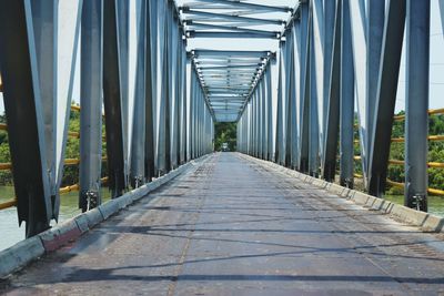 Walkway in city against sky