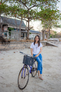 Portrait of smiling young woman on bicycle