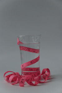 Close-up of red glass against white background