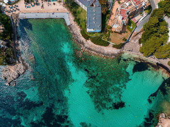 Aerial drone top down photo of small emerald sea tropical port