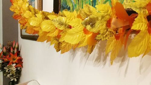 High angle view of yellow flowers in vase on table