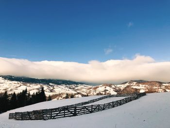 Scenic view of snow covered mountains against sky