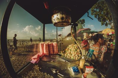 People for sale at market stall