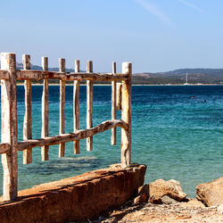 Railing against sea and sky on sunny day