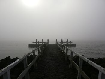 Pier over sea against sky