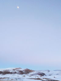 Scenic view of sea against clear sky during winter
