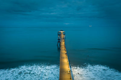 Drone view of imperial beach pier at dawn. boat lights in distance