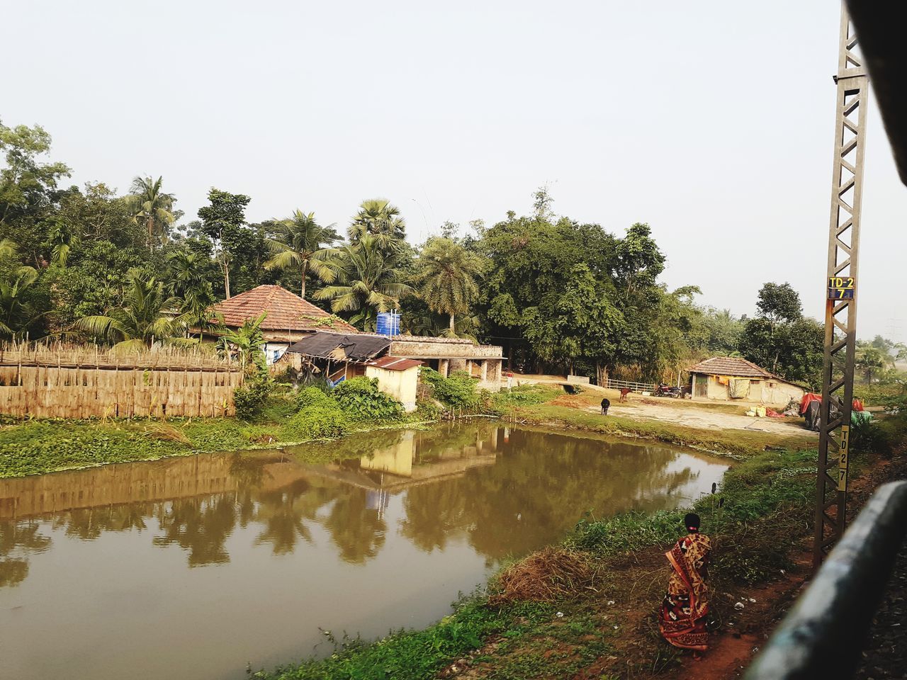 REFLECTION OF TREES AND HOUSES IN CANAL