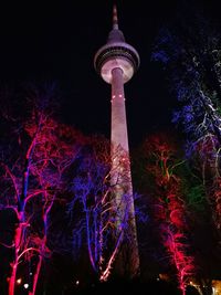 Low angle view of illuminated building against sky at night