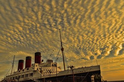 Low angle view of built structure against sky at sunset