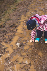High angle view of child standing on sand