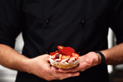 Midsection of man holding food