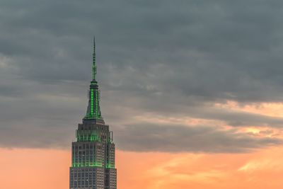 Low angle view of tower against cloudy sky