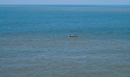 Boat sailing in sea against sky