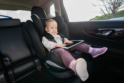 Low section of woman sitting in car