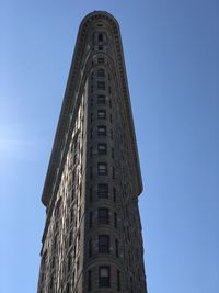 Low angle view of historical building against clear blue sky