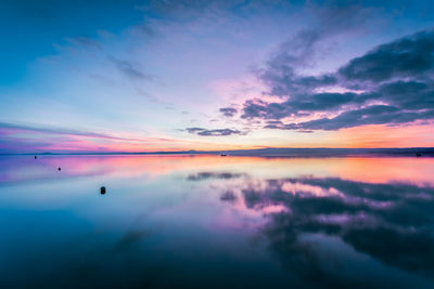 Reflection of sky on lake bolsena during sunset