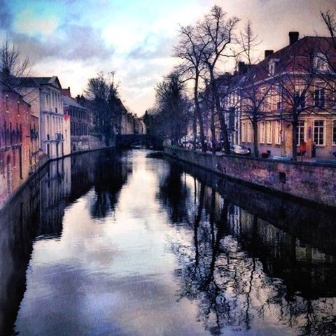 architecture, built structure, water, building exterior, canal, reflection, waterfront, river, sky, tree, bare tree, connection, arch bridge, bridge - man made structure, house, arch, residential building, residential structure, cloud - sky, building