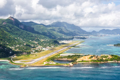 Scenic view of sea and mountains against sky