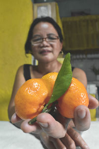 Close-up of woman holding fruit